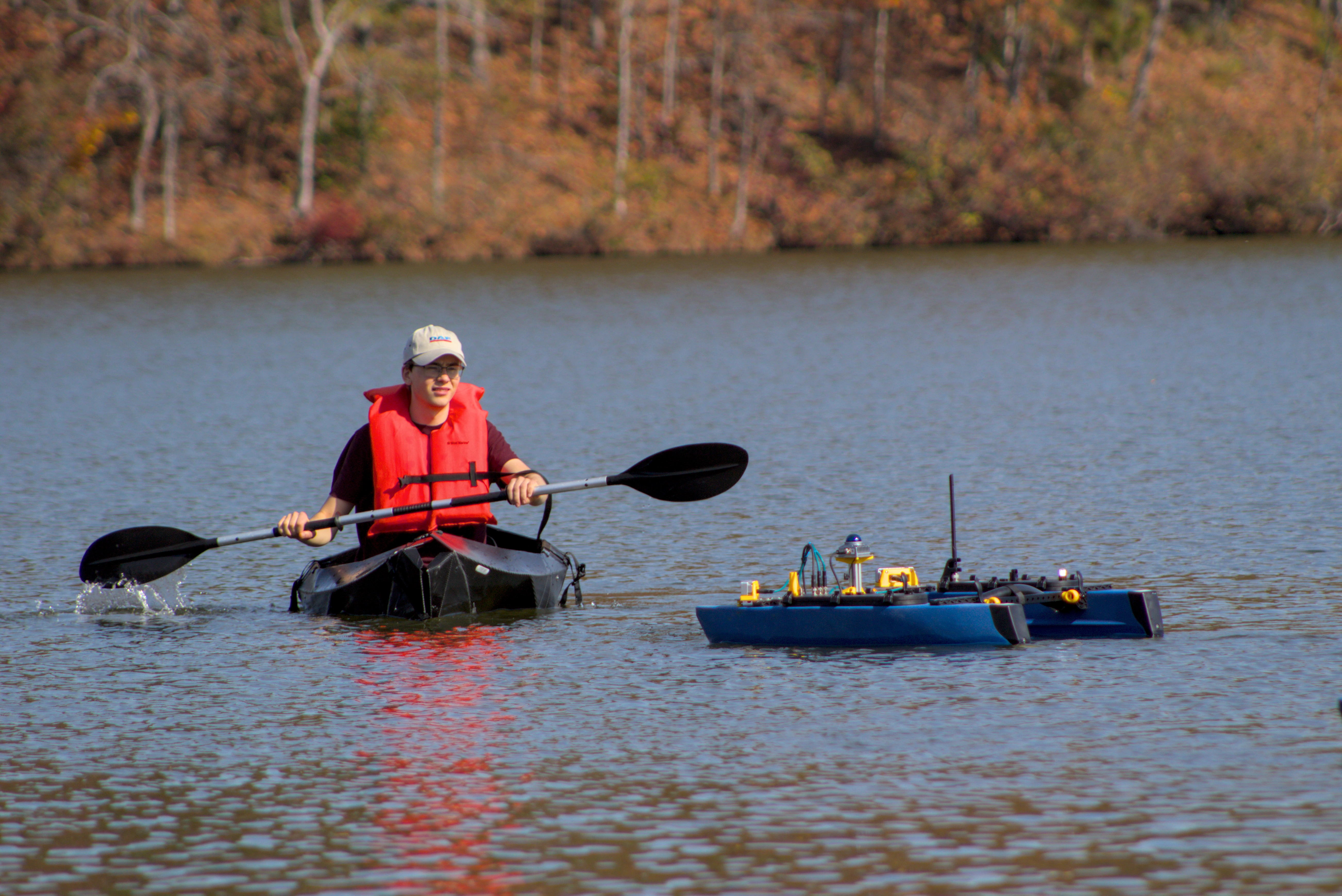 Members testing a robot at a local lake
